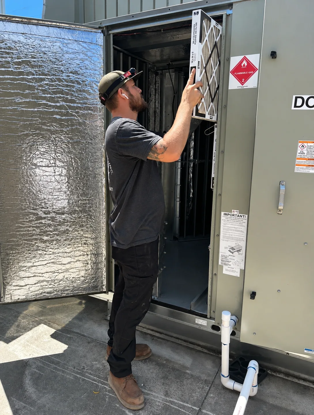 Collins Mechanical air conditioning technician replacing an HVAC filter