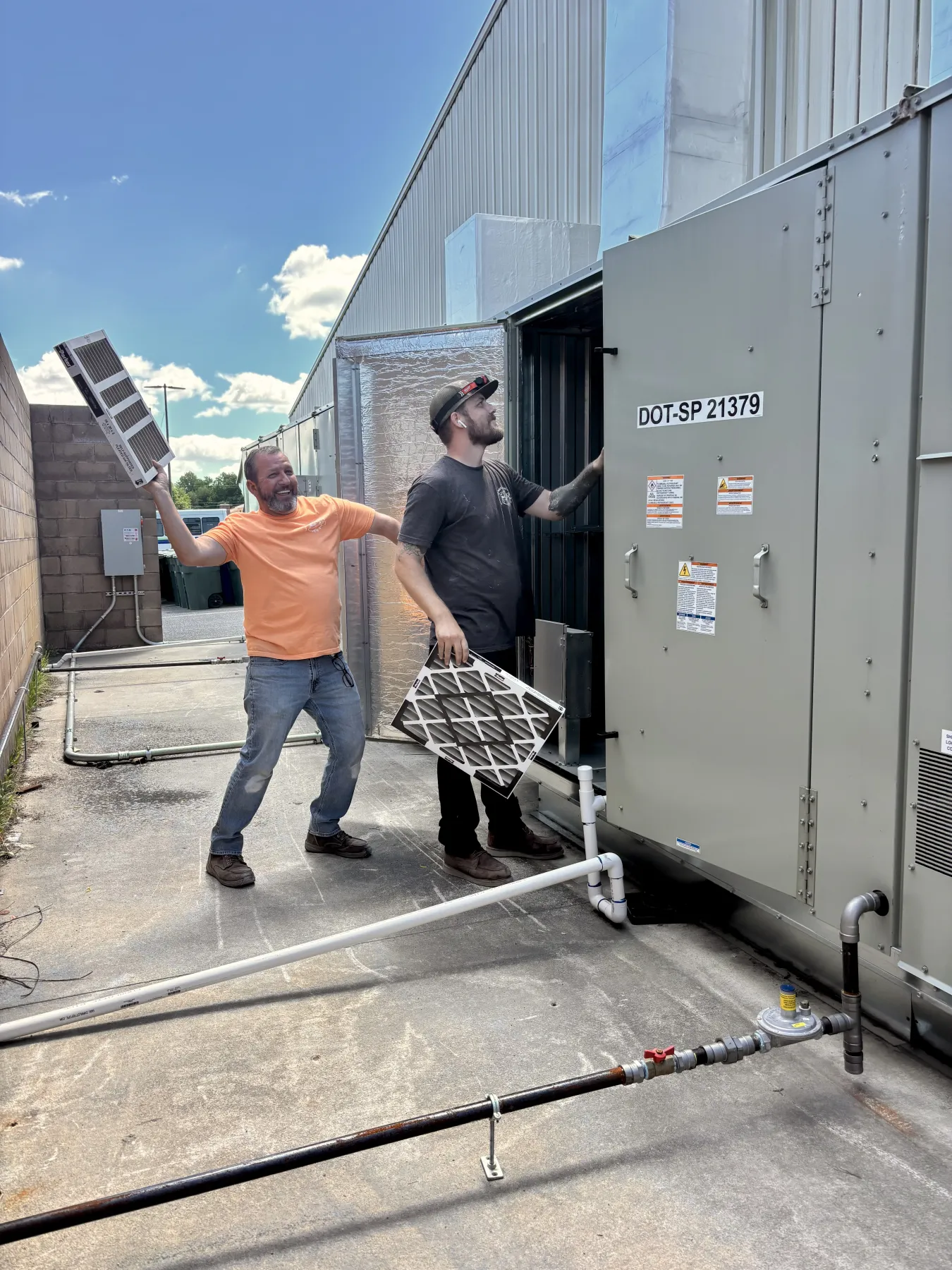 Collins Mechanical technicians servicing the rooftop HVAC unit at DE State Memorial Hall