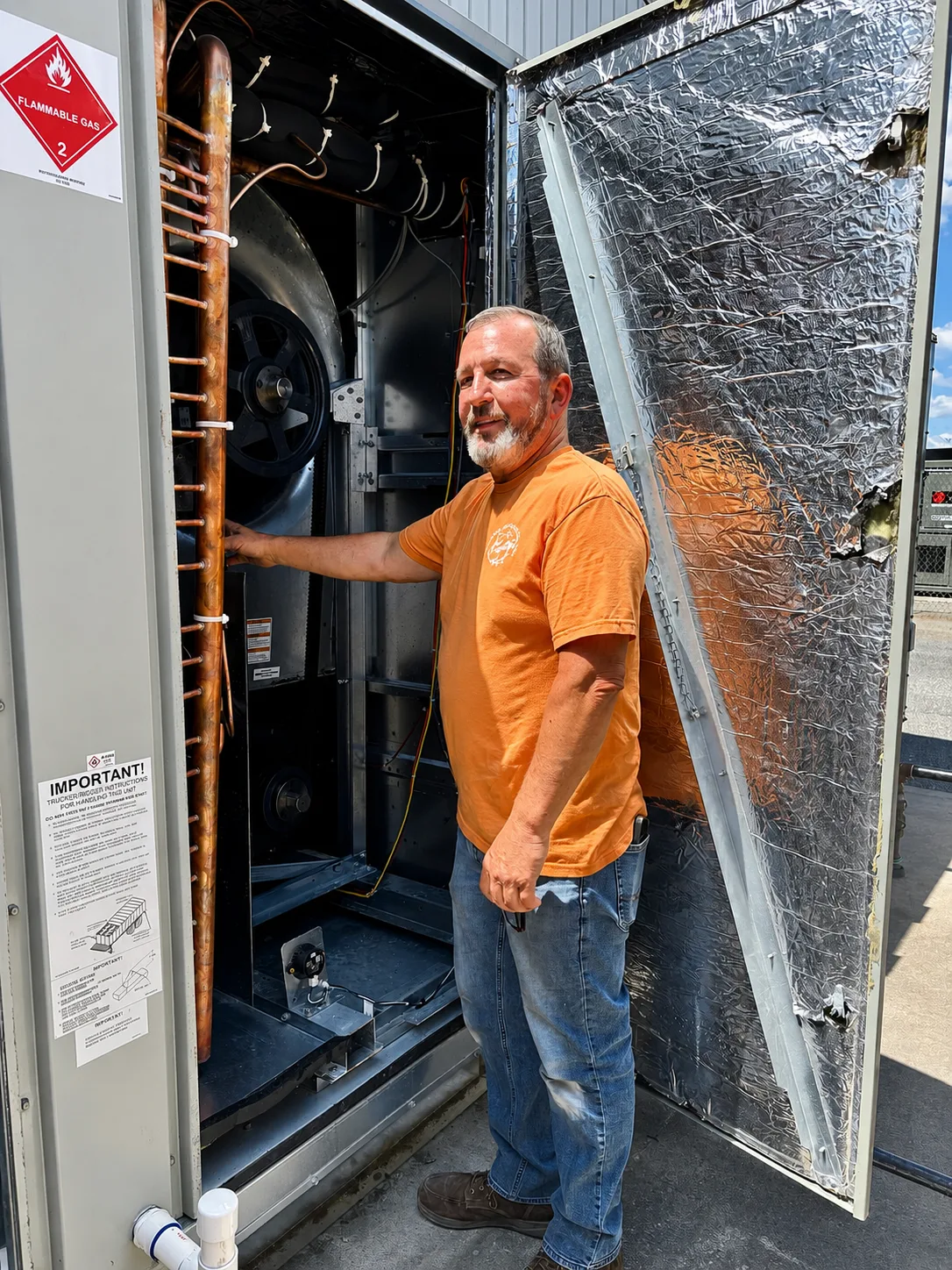 Collins Mechanical heating technician servicing a commercial HVAC unit